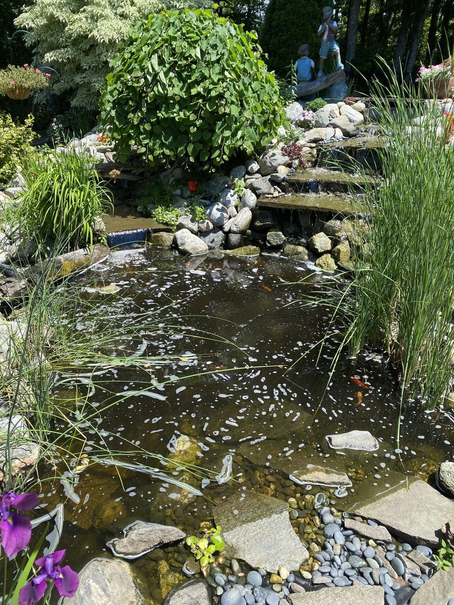 Custom water feature with natural stone landscaping in Central Massachusetts
